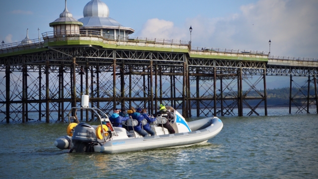 A stationery RIB with passengers on the Menai Strait close to Bangor Pier